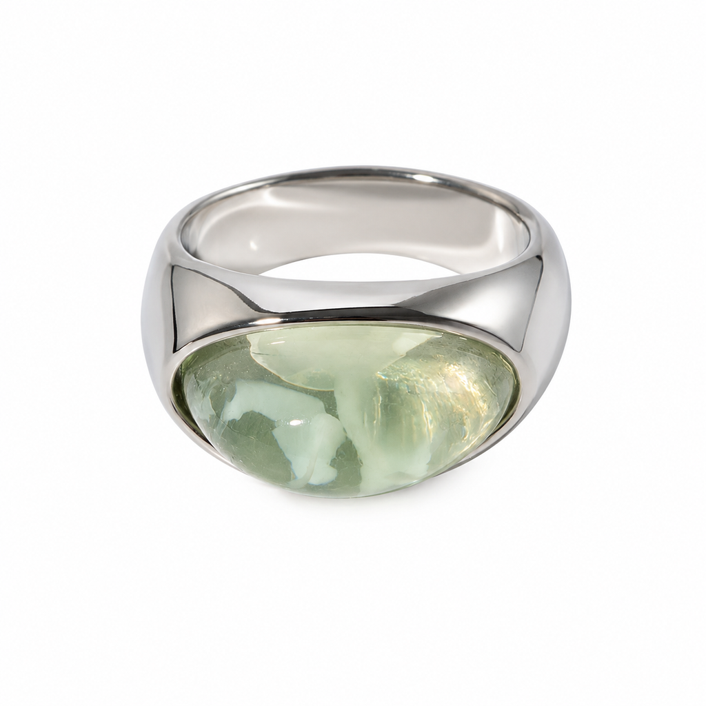 A polished silver signet ring featuring a large, rounded, east-west green gemstone, set against a plain white background.